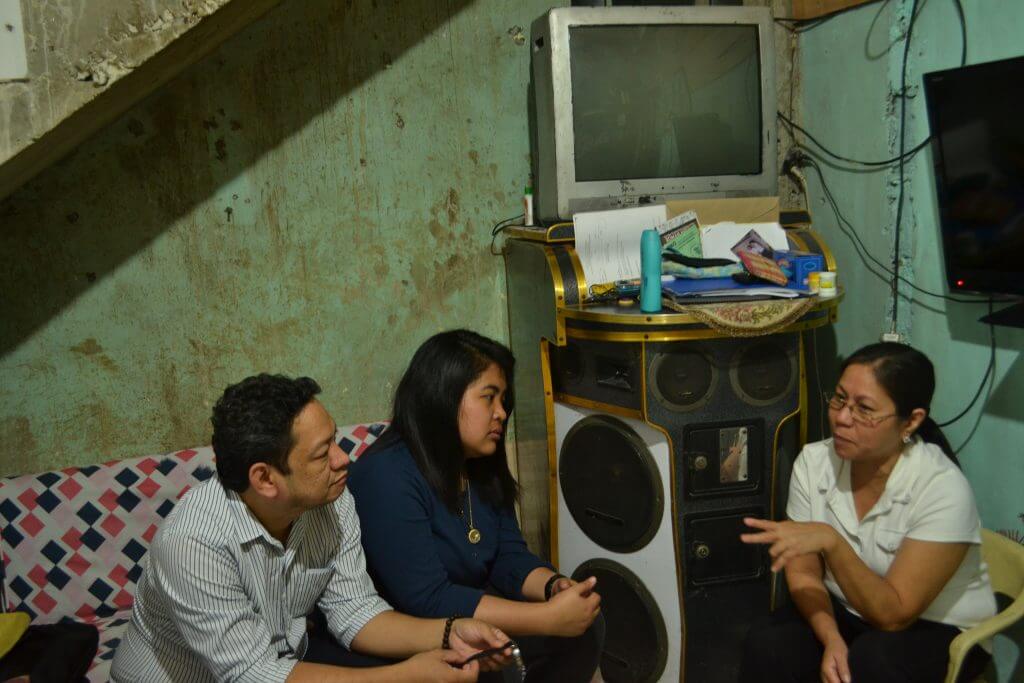 Pioneer Microinsurance staff in dialogue with a customer
